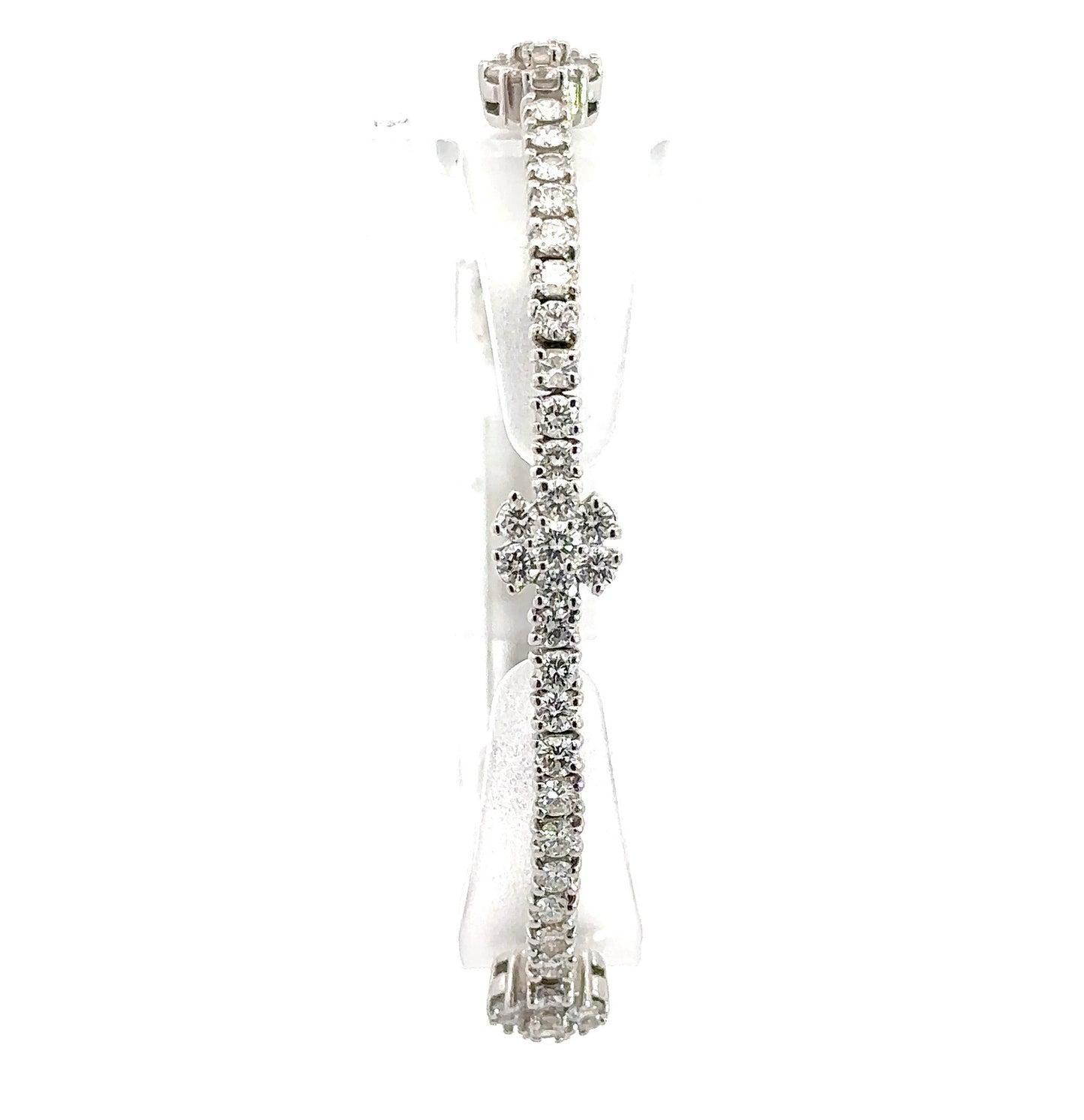 Front of diamond flower bracelet with round diamonds in a line and clusters of round diamonds making up a flower