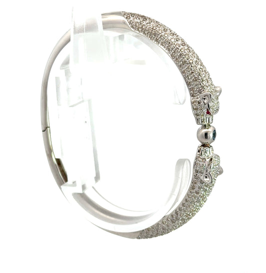 Side of white gold bangle with 2 panthers with small round diamonds on half the bracelet