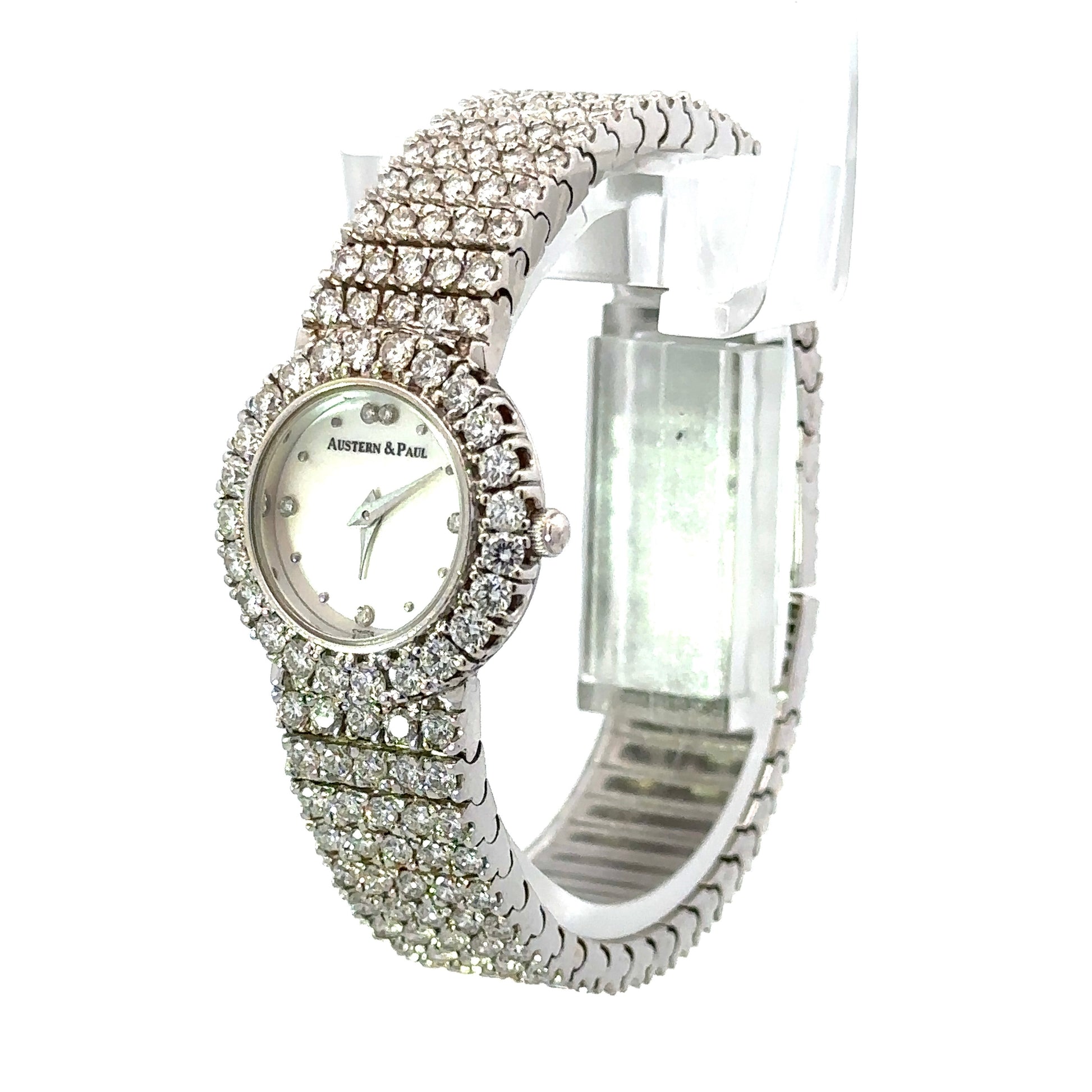 Diagonal front of watch with white dial and diamonds on the bezel and band
