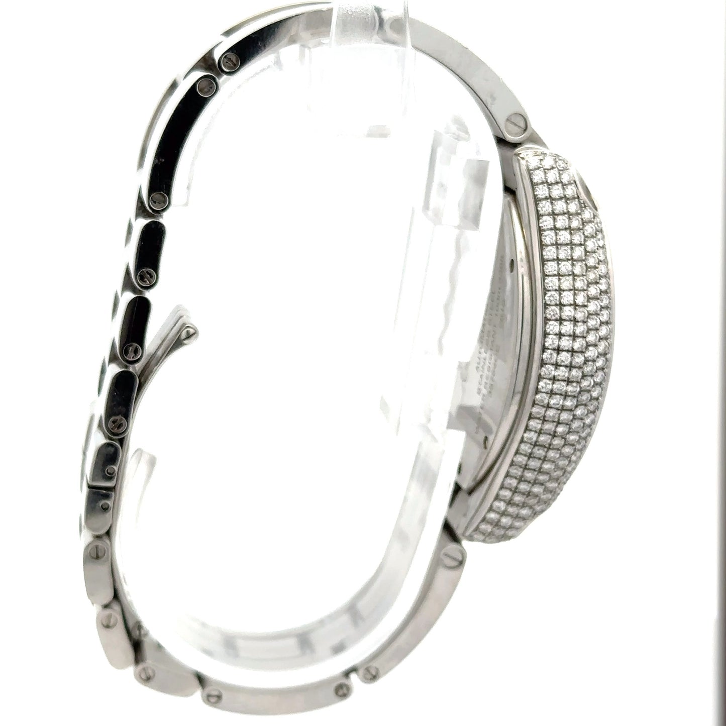 The side of the Cartier watch. Diamonds on the side of the face. Scratches shown on the band.