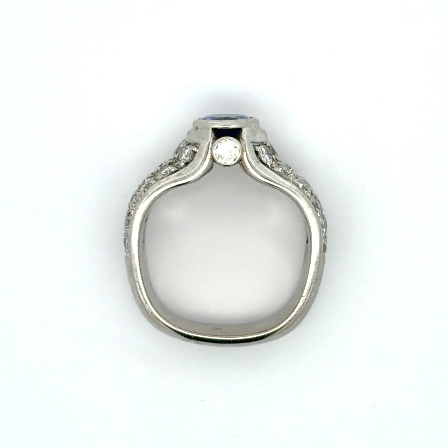 White gold ring with a Tanzanite oval gemstone and diamond accents on a white background