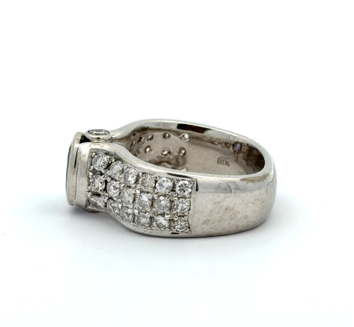 White gold ring with a Tanzanite oval gemstone and diamond accents on a white background