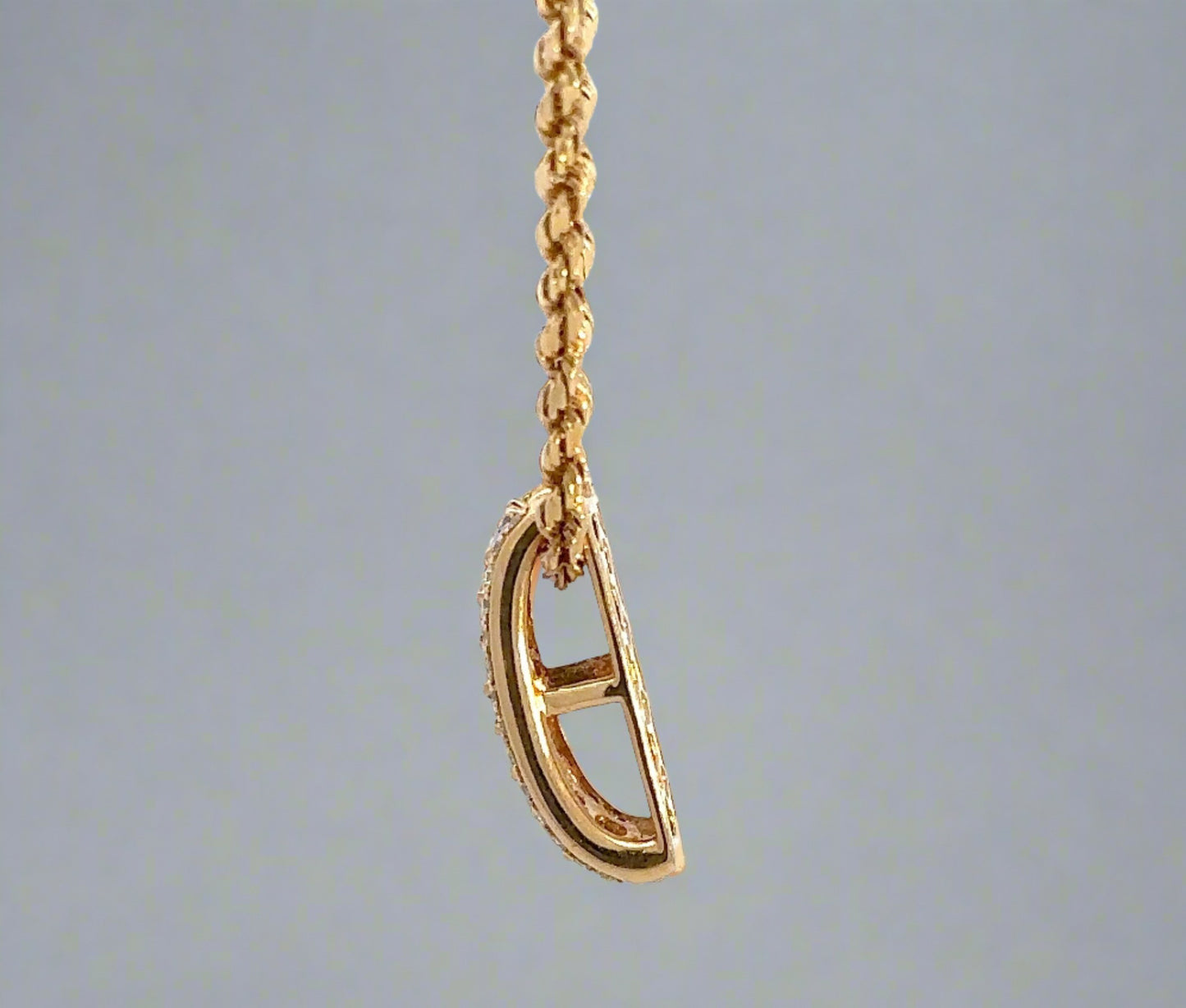 side of yellow gold pendant