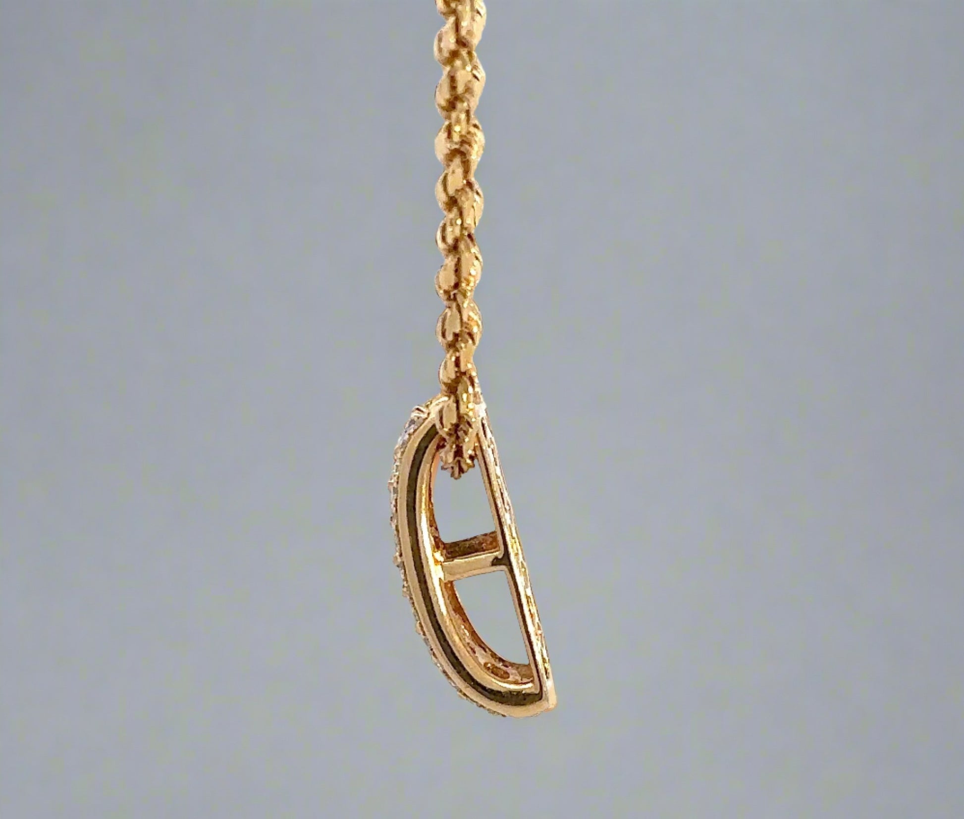 side of yellow gold pendant
