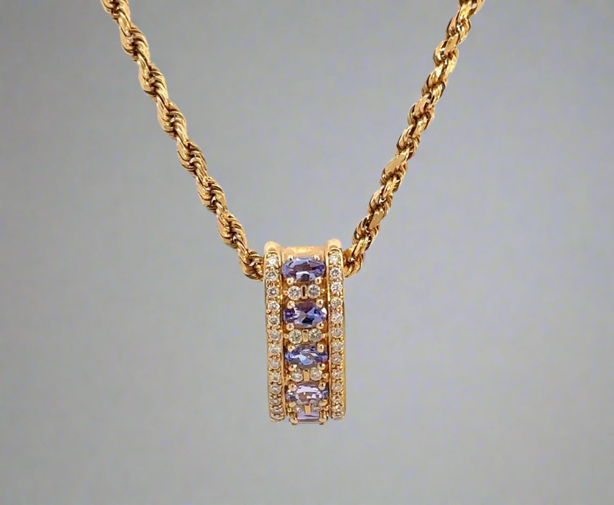 front of yellow gold rope chain and yellow gold diamond and gemstone pendant