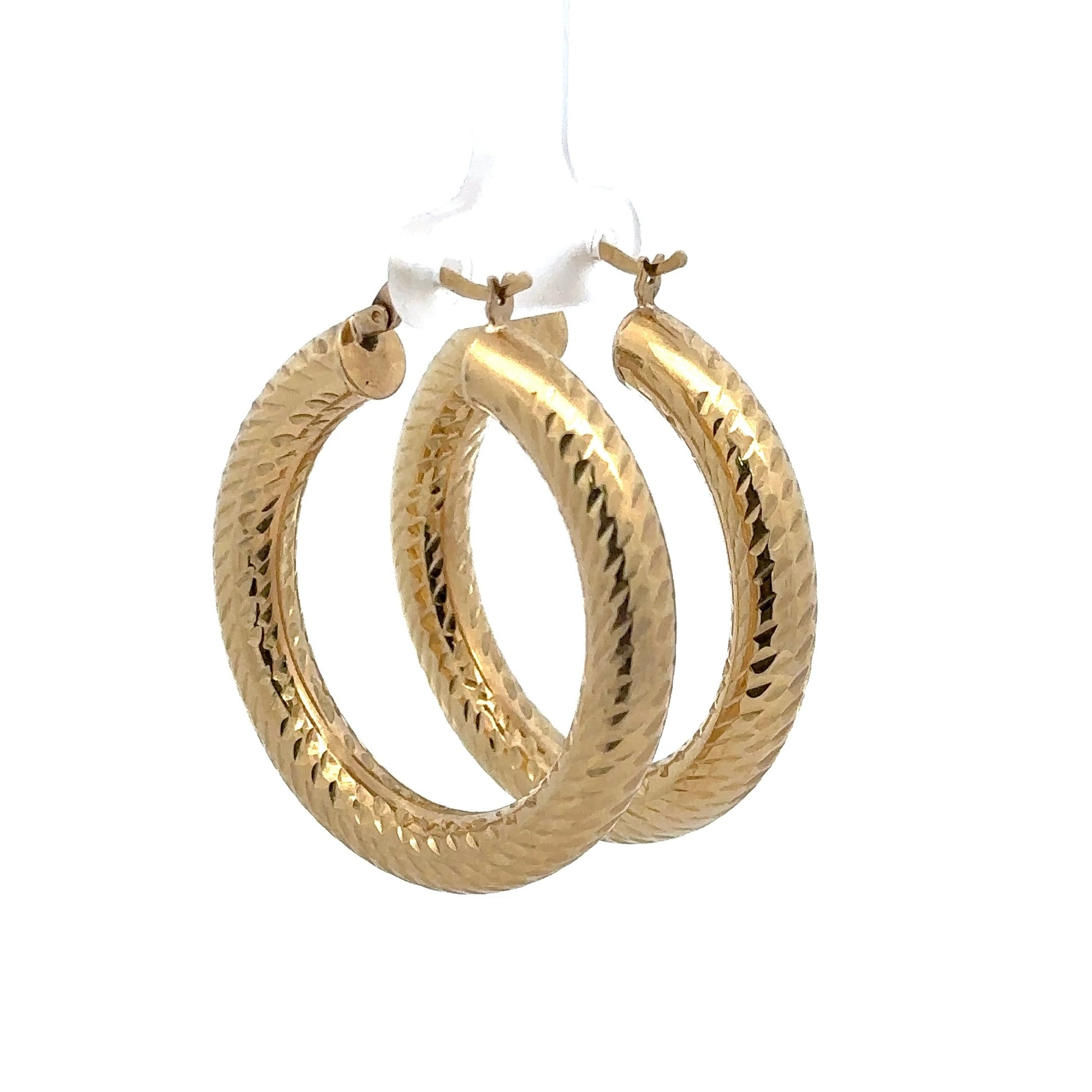 Diagonal back of yellow gold textured hoops.