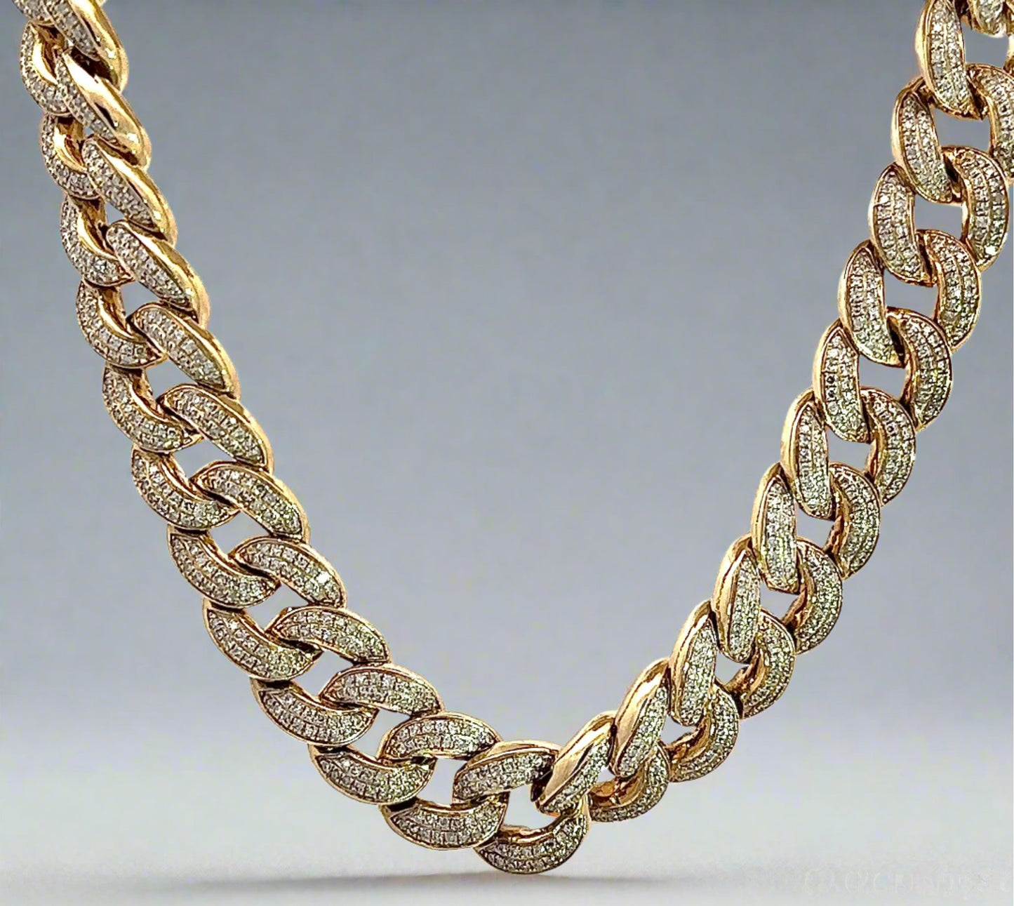 Hanging yellow gold diamond cuban link chain