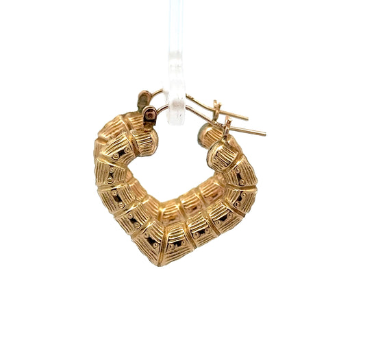 side of yellow gold bamboo heart hoops with 10K stamp on post + tarnishing marks on post.