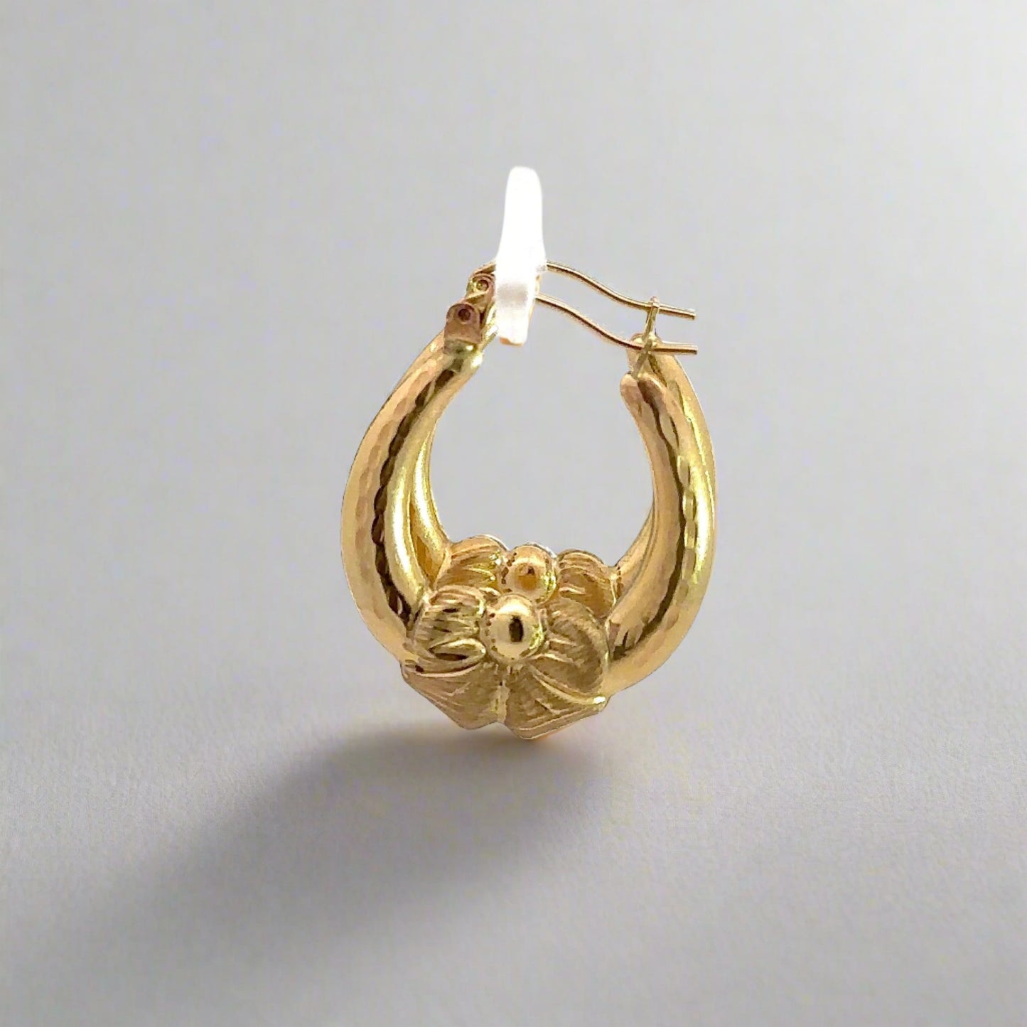 Side of yellow gold bow hoops