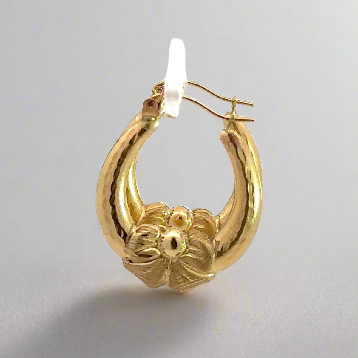 Side of yellow gold bow hoops