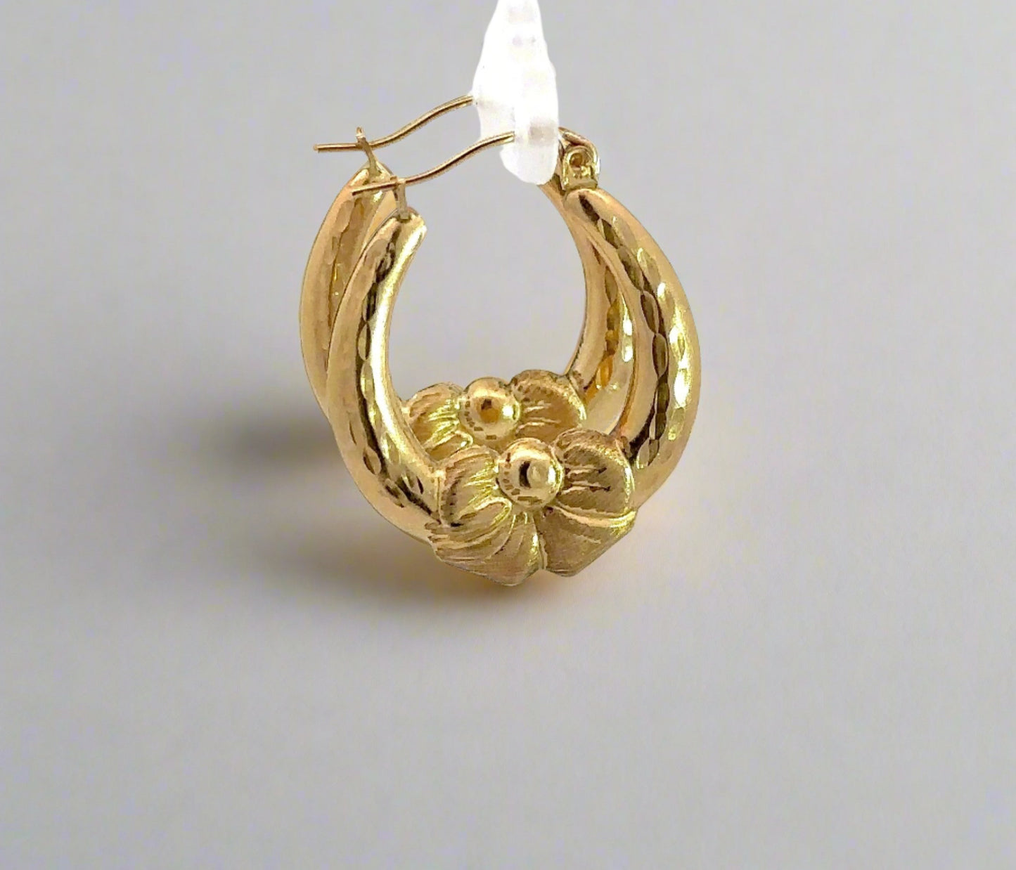 Side of yellow gold bow hoops
