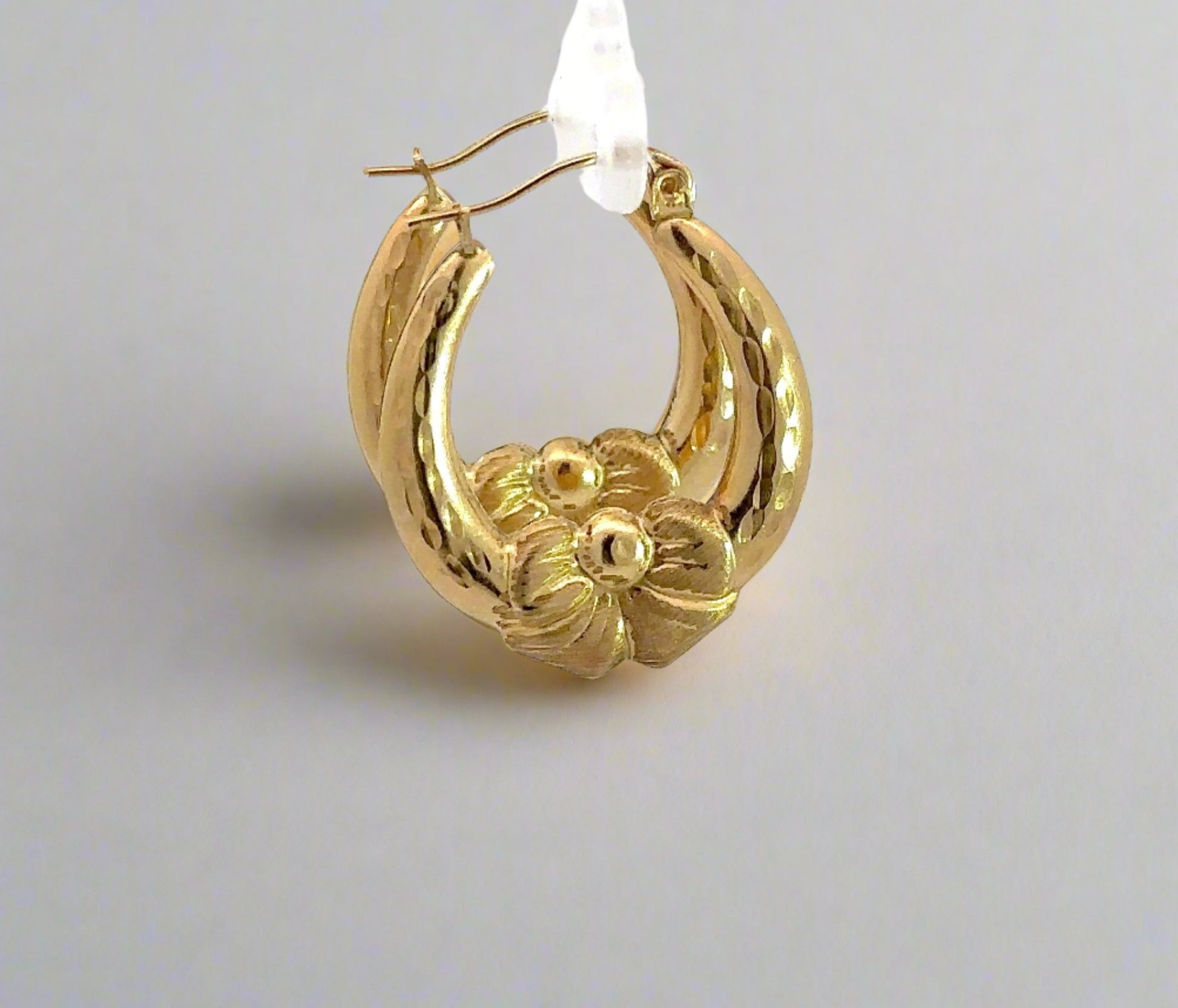 Side of yellow gold bow hoops
