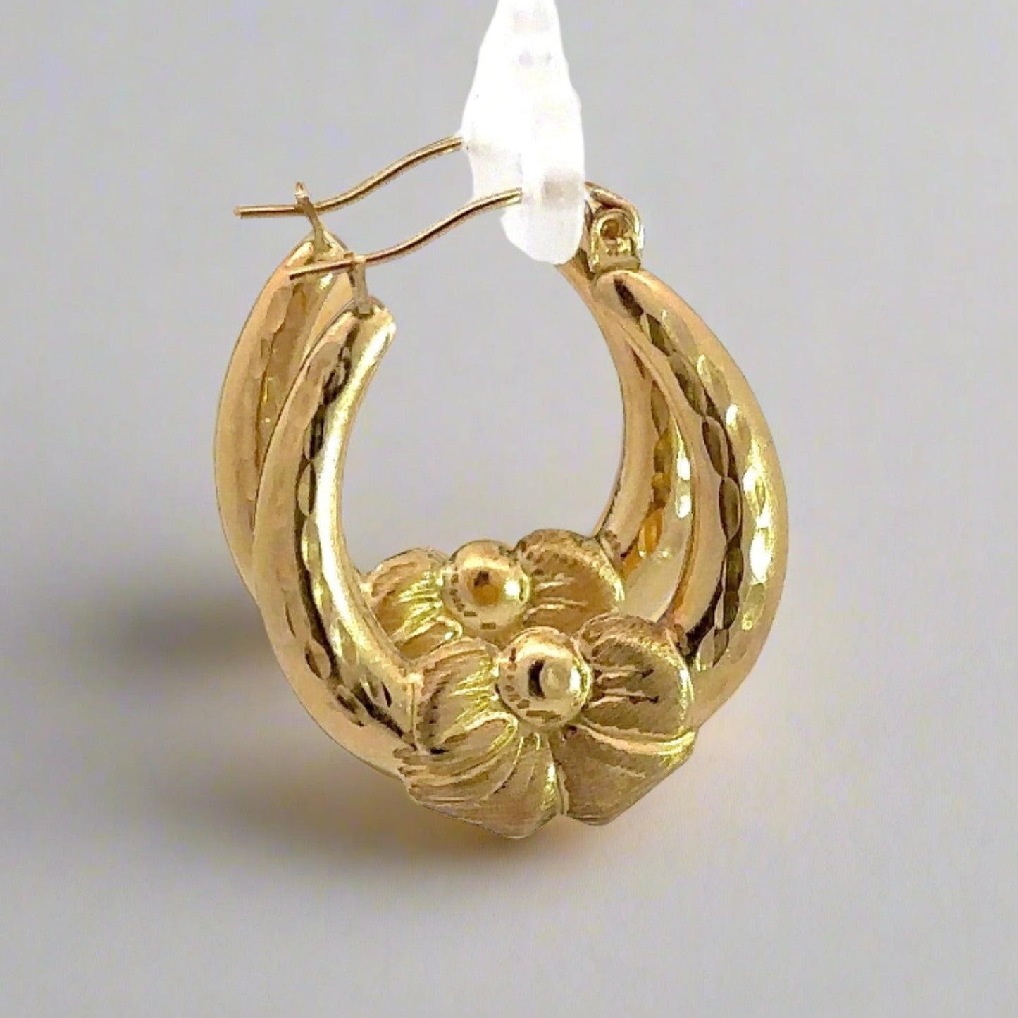 Side of yellow gold bow hoops