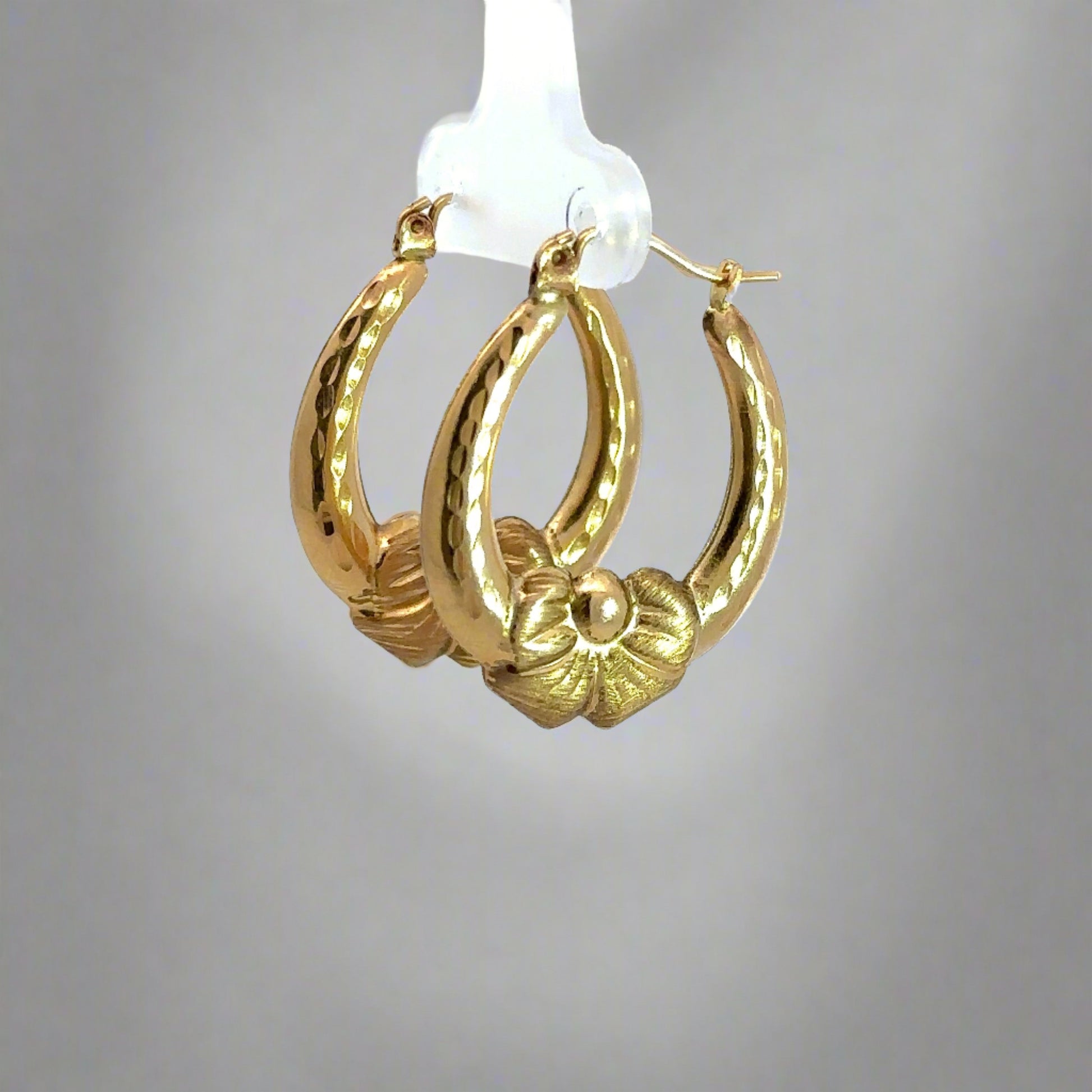 Diagonal view of yellow gold bow hooops
