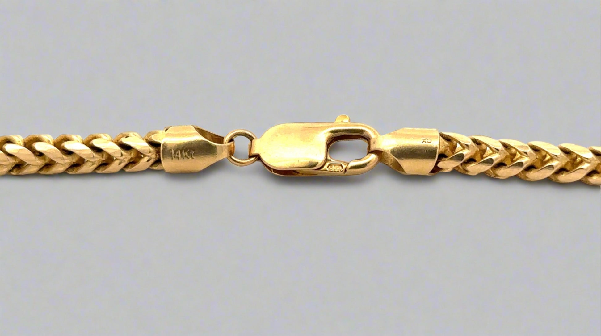 Close up of lobster clasp with 14K stamp