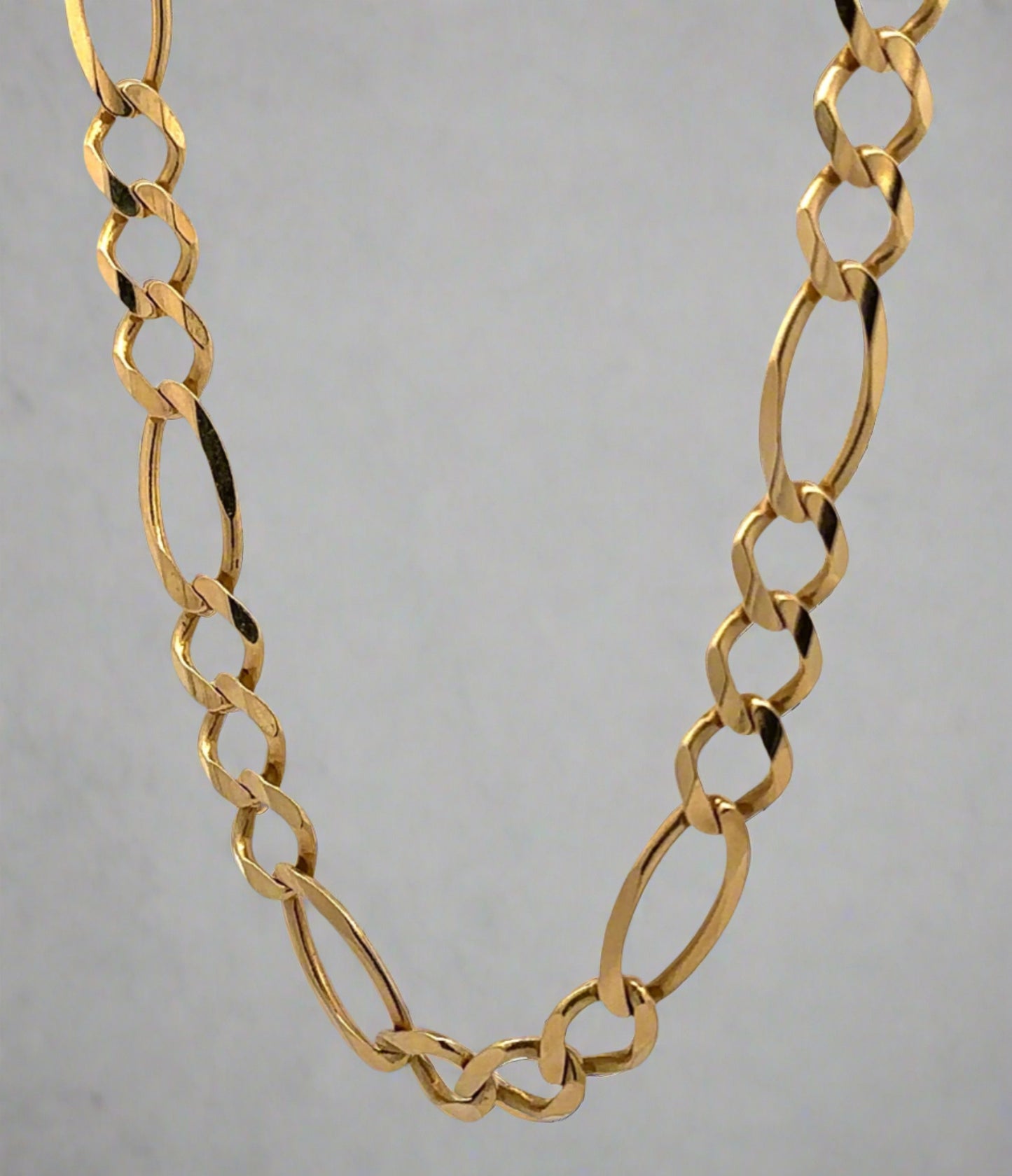 hanging yellow gold figaro link chain