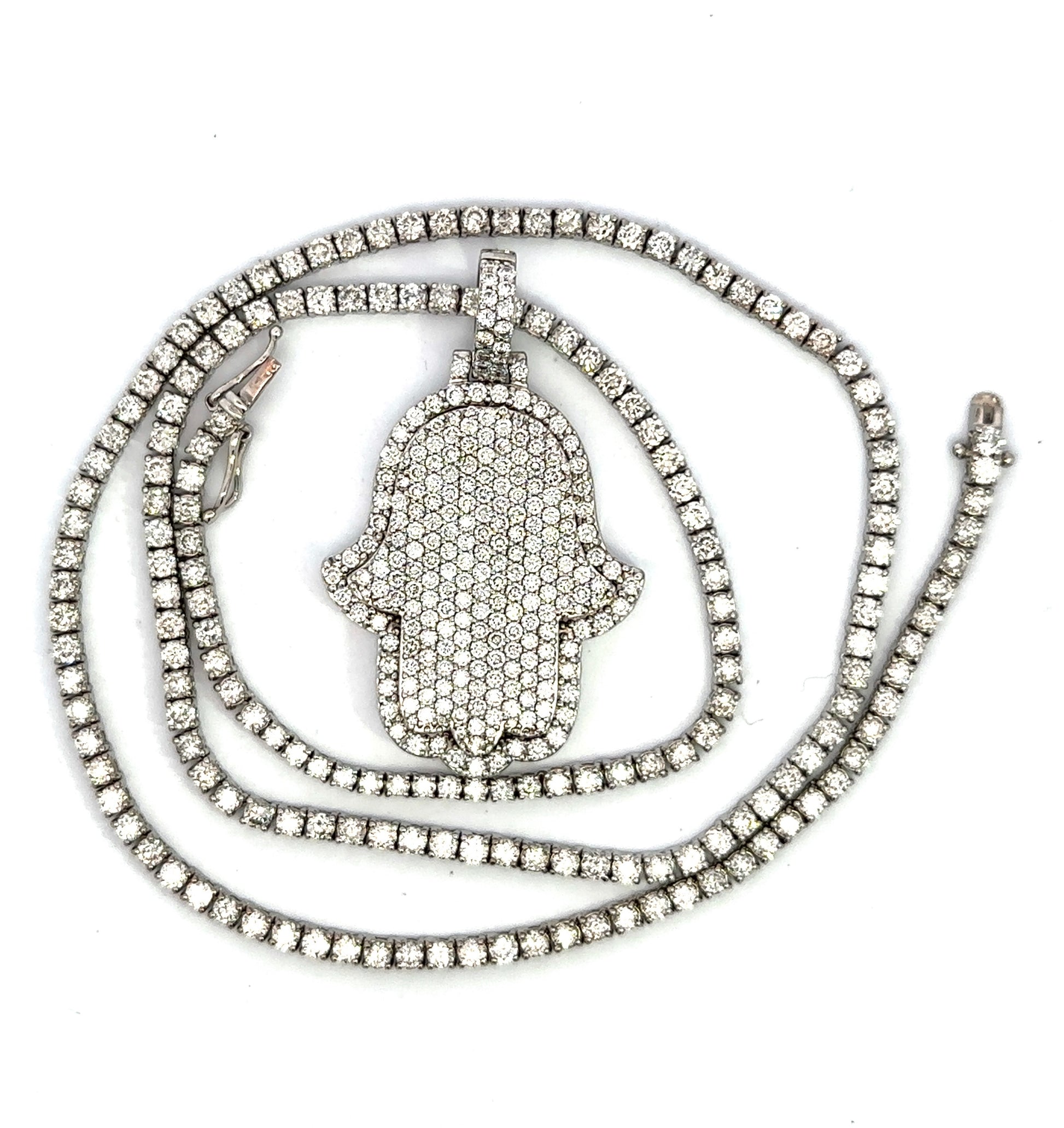 lying down diamond tennis chain and hamsa pendant