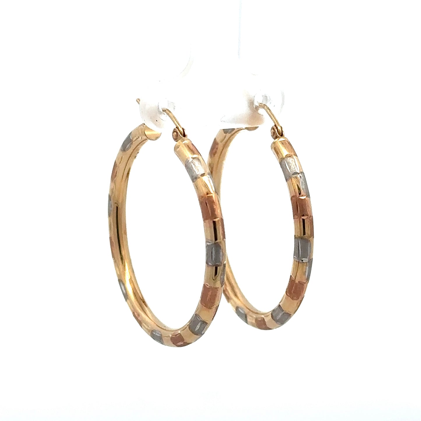 Diagonal front of tri-color gold hoops