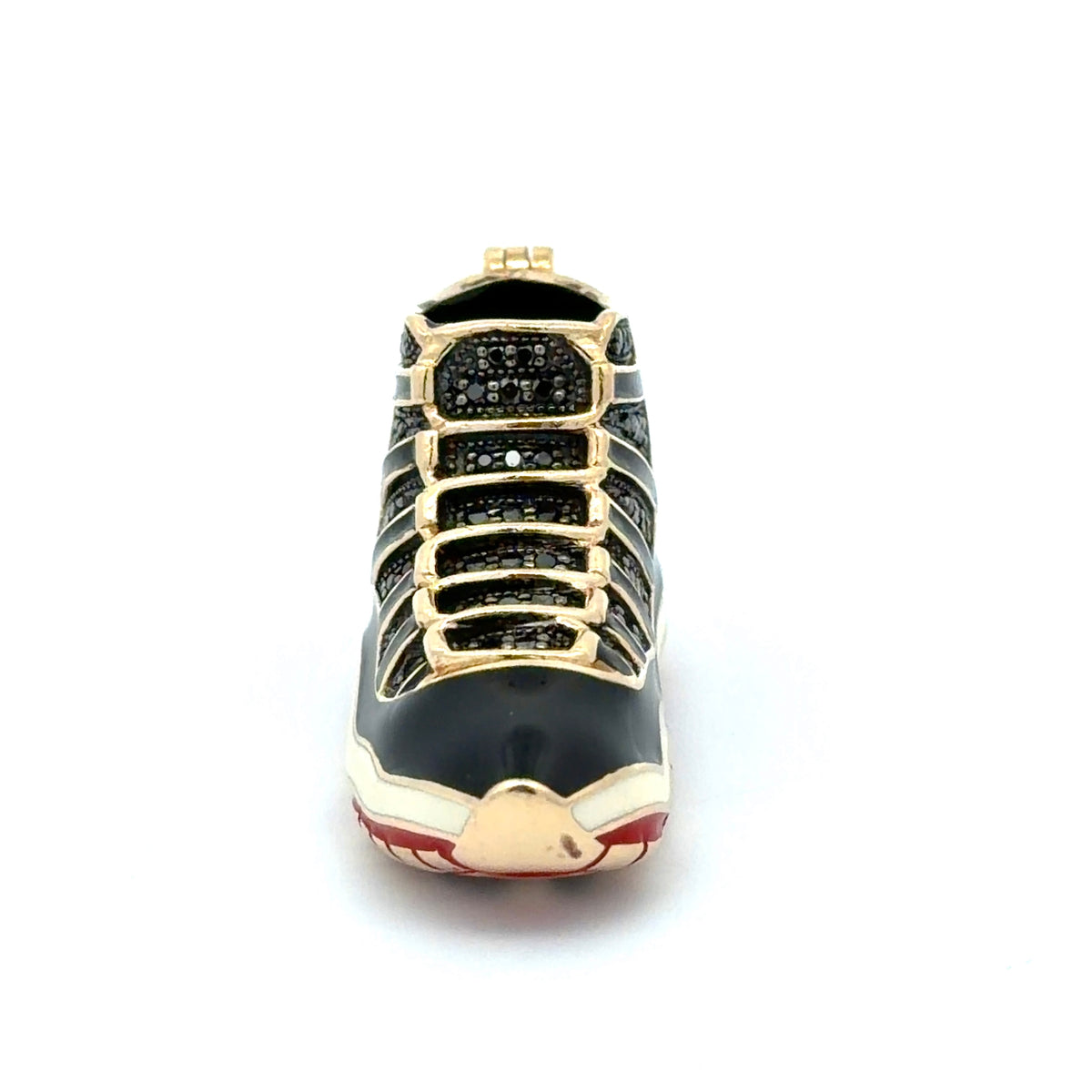 Decorative shoe ornament with gold accents on a white background