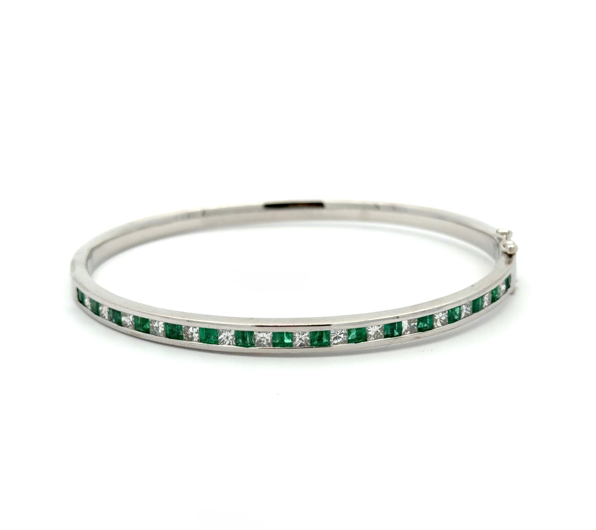 White gold princess-cut diamond and emerald bangle bracelet on white background