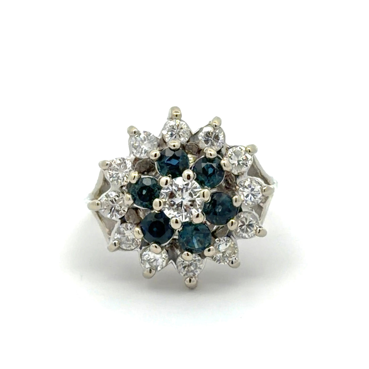 Diamond and blue gemstone ring on a white background