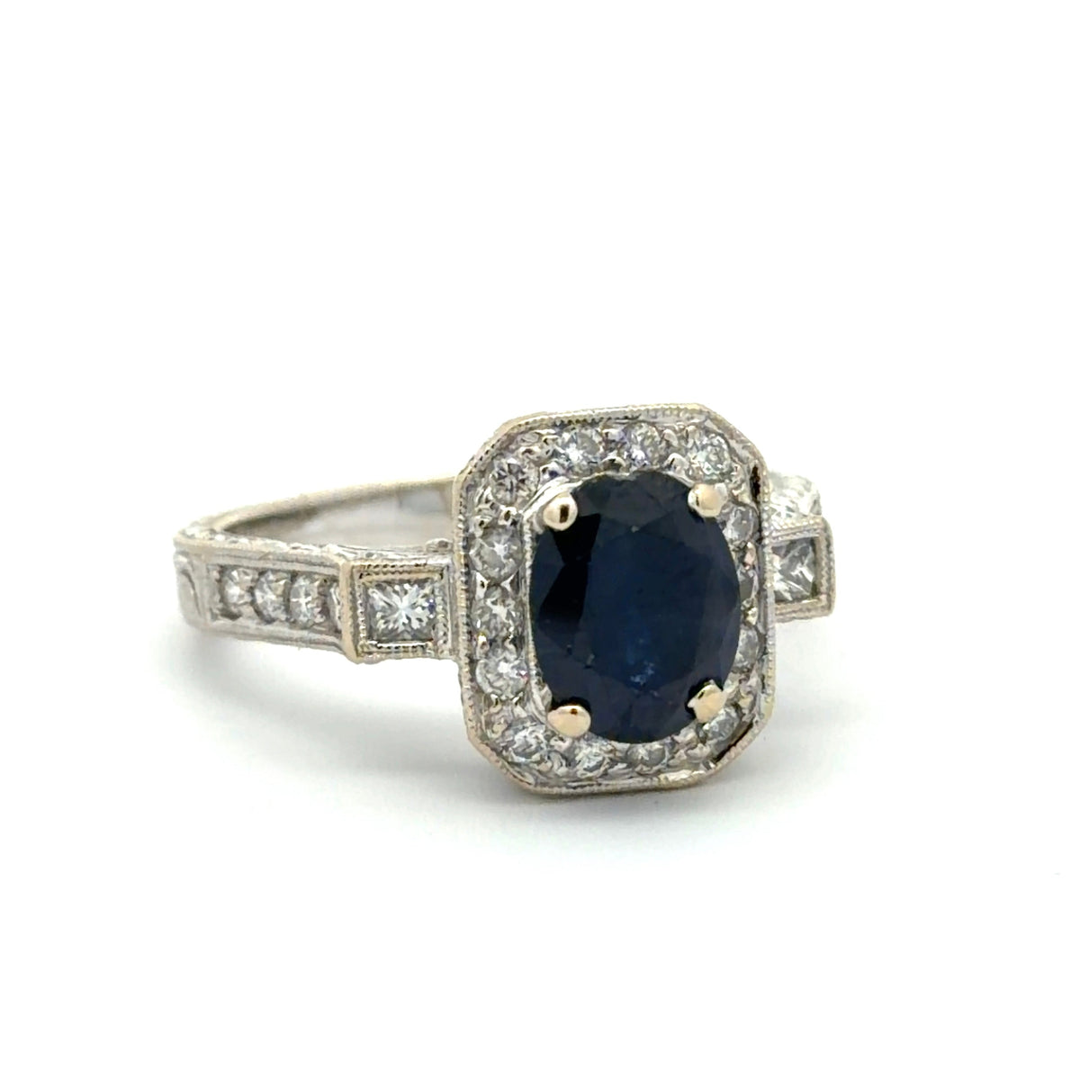 White gold ring with a blue gemstone and diamond accents on a white background