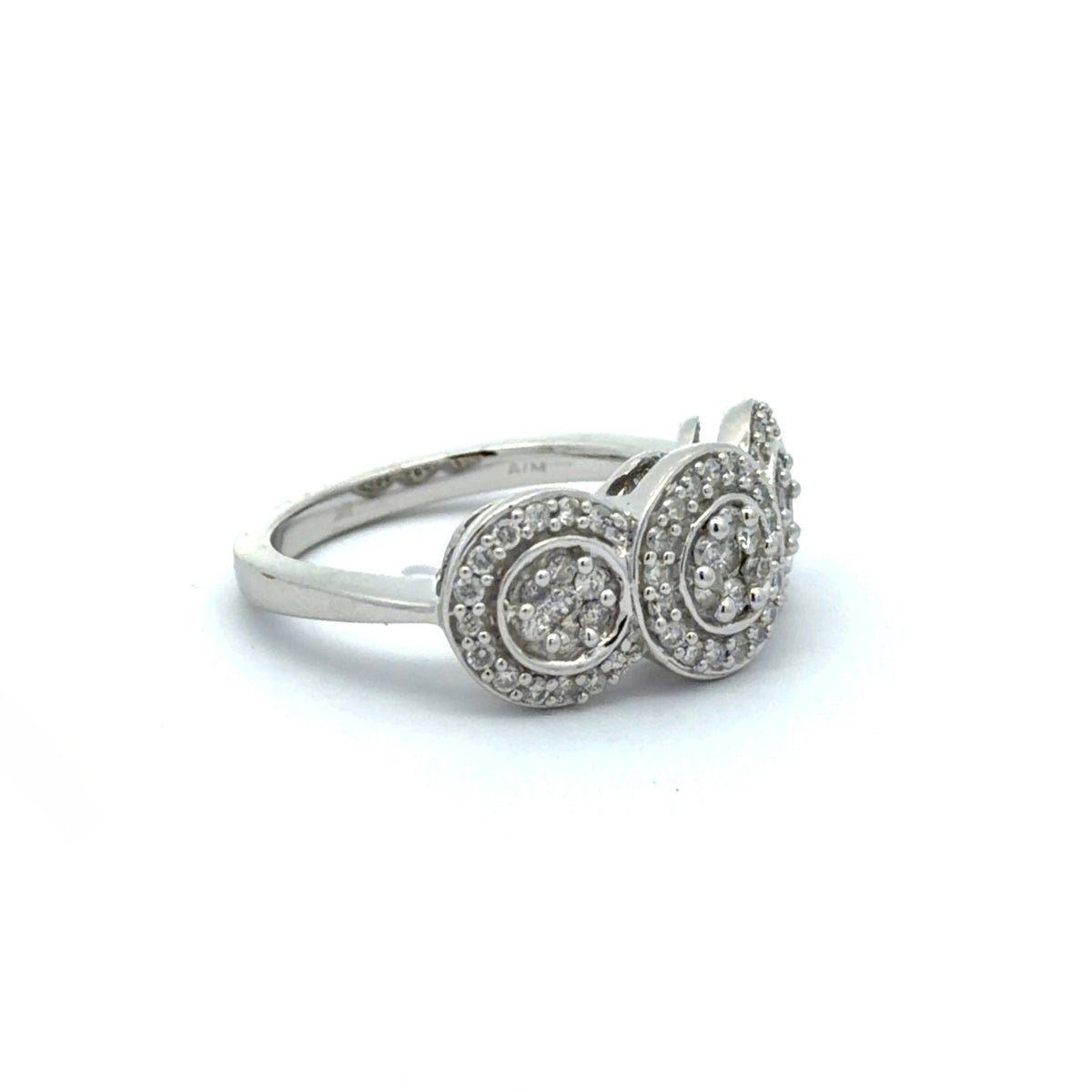 White gold ring with three circular diamond settings on a white background