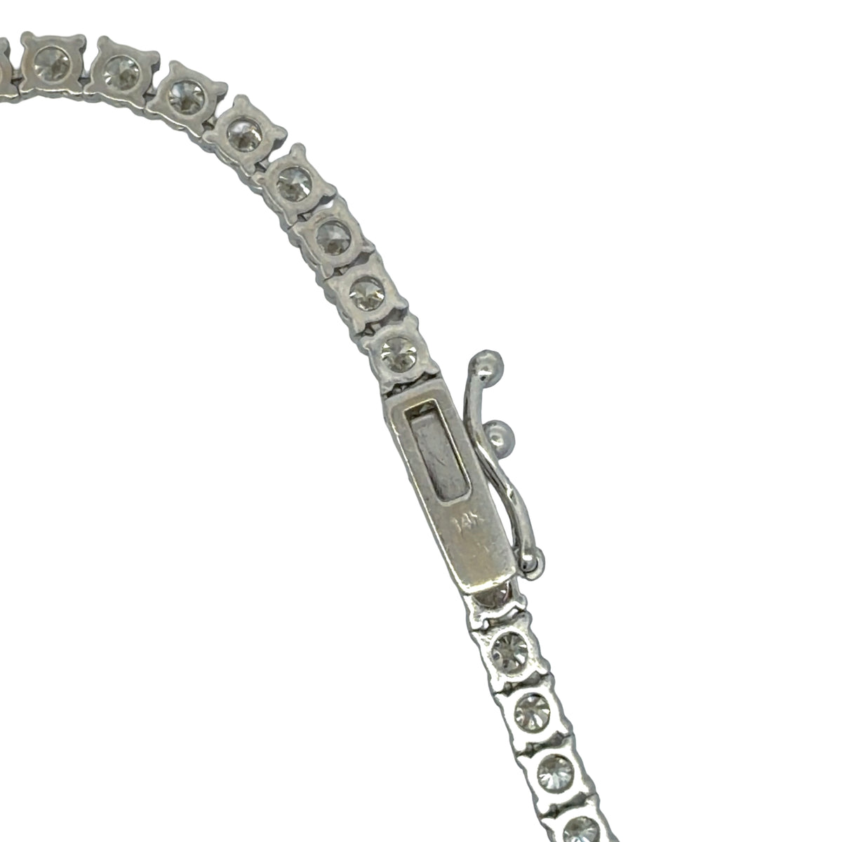 Close-up of white gold diamond tennis necklace box clasp and safety catch
