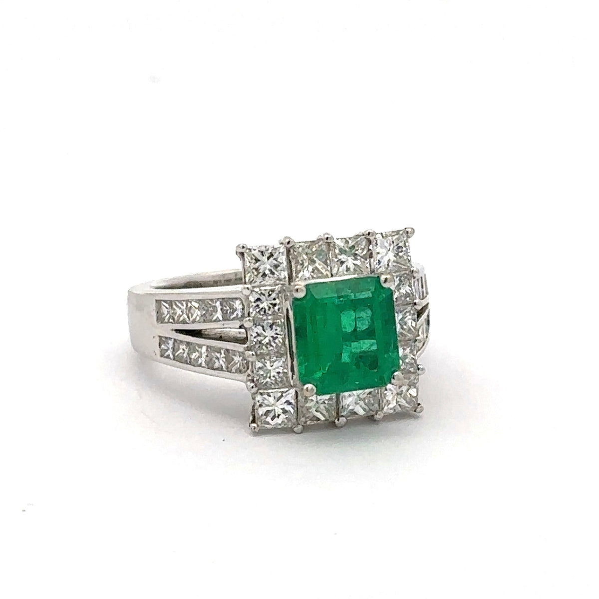 Ring with a green gemstone and diamond accents on a white background
