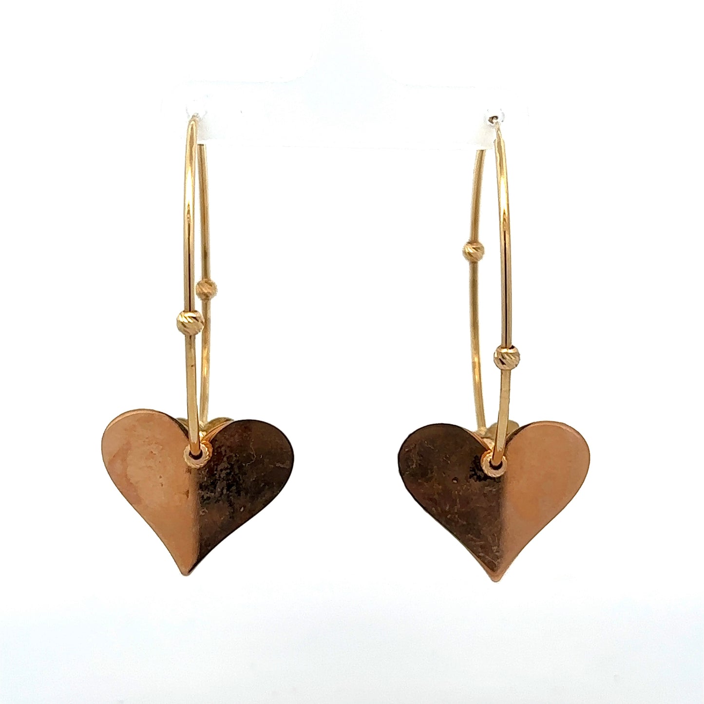 Back of hoops with rose gold hearts and marks on the back of the hearts