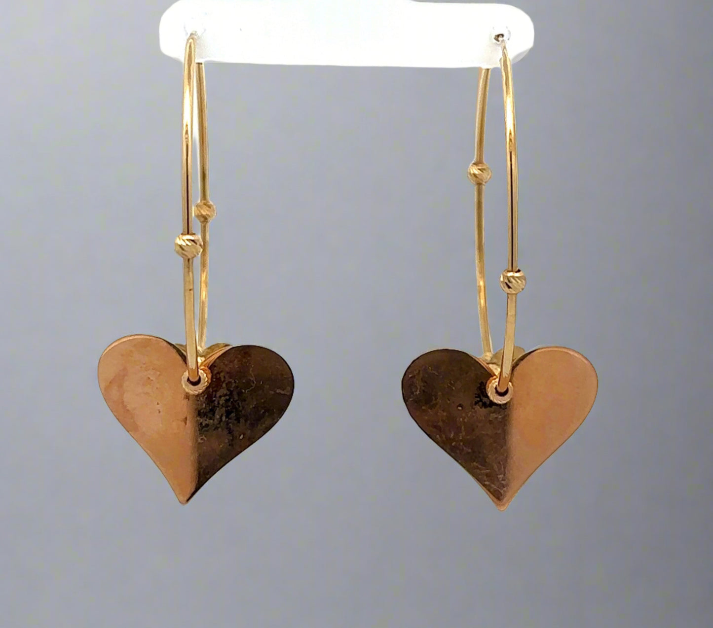 Back of hoops with rose gold hearts and marks on the back of the hearts
