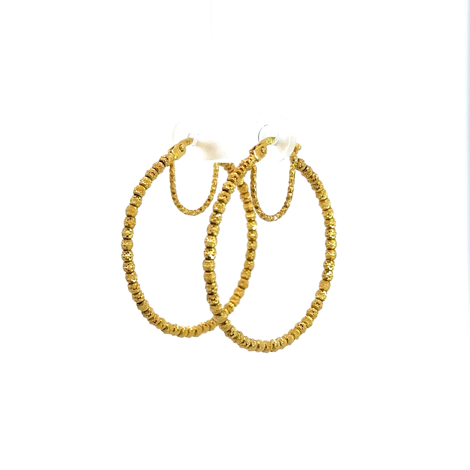 diagonal view of yellow gold hoops