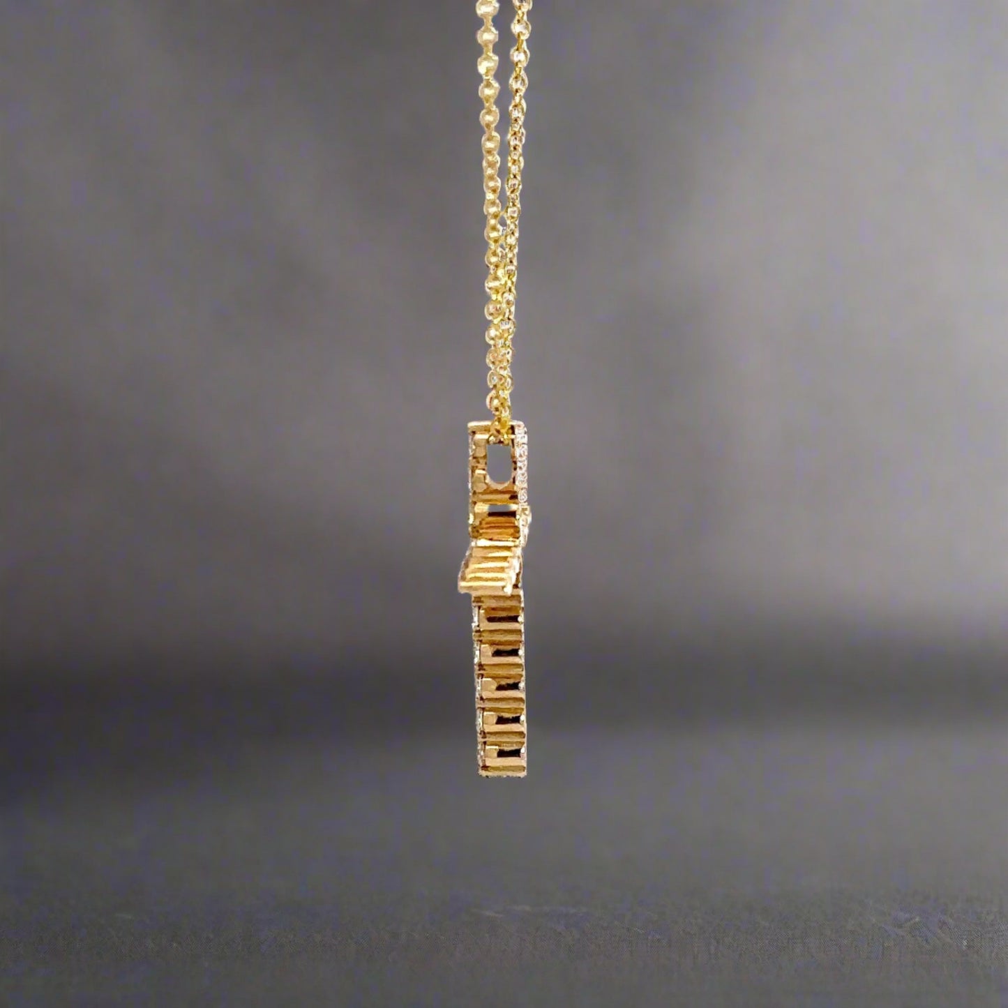side of yellow gold cross necklace