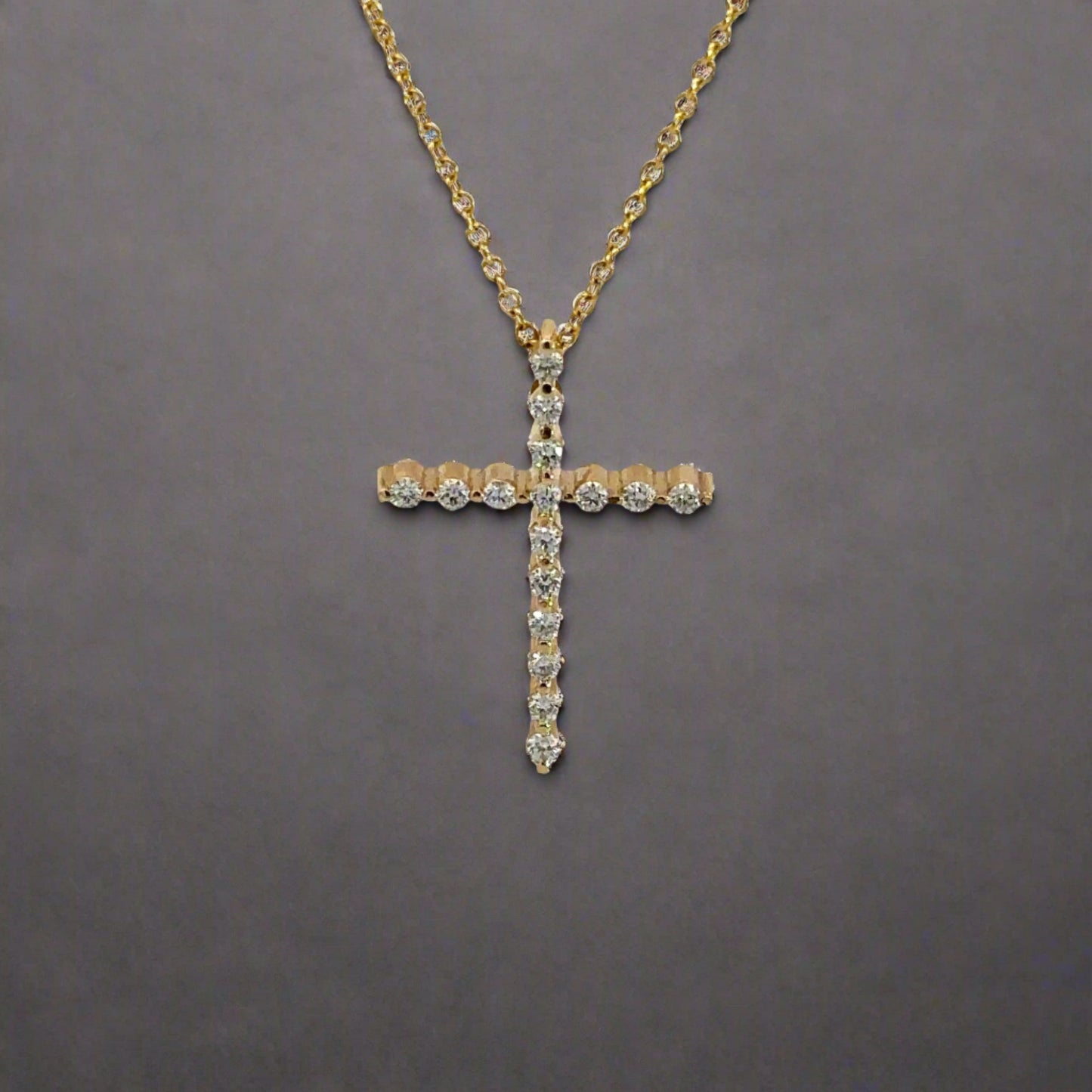 front of yellow gold diamond cross necklace