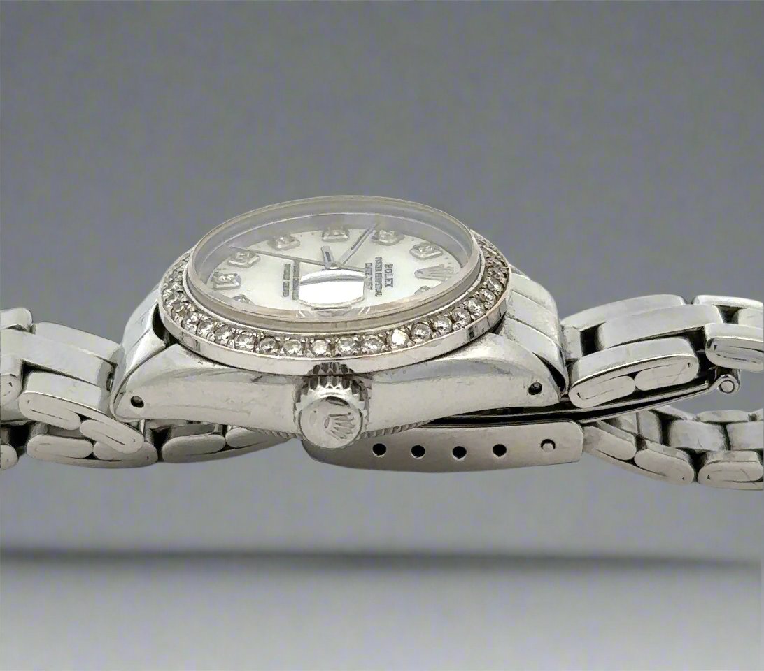 Side of watch with crown and scratches