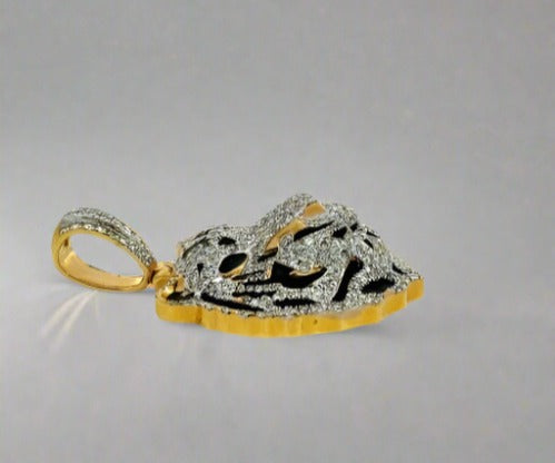 Side of diamond tiger pendant. Scratches on gold.