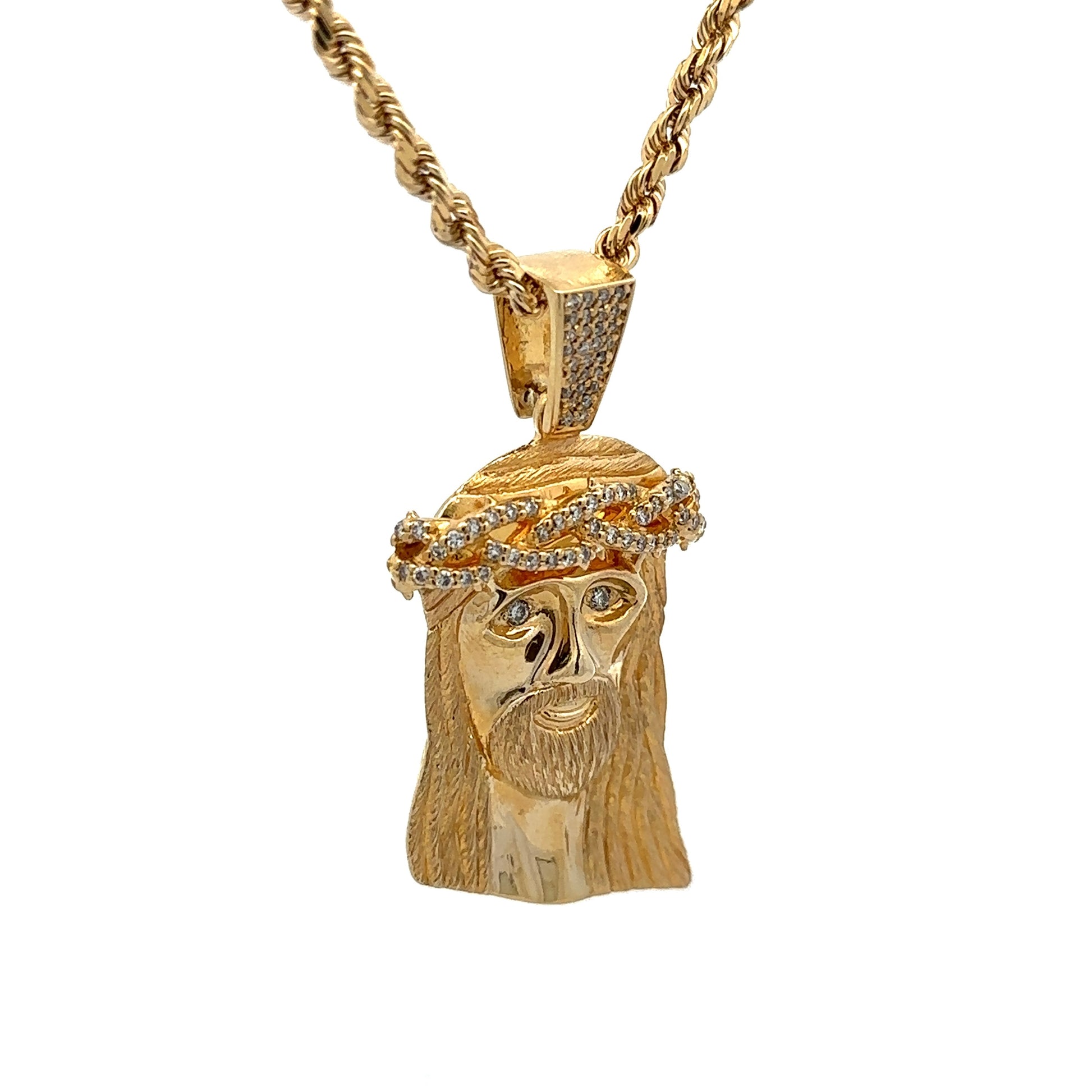 diagonal view of yellow gold rope chain and jesus head pendant