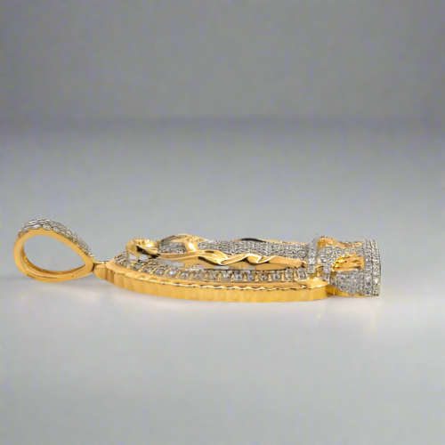 Side of Diamond Virgin Mary pendant. Scratches on gold. Has a round bail.