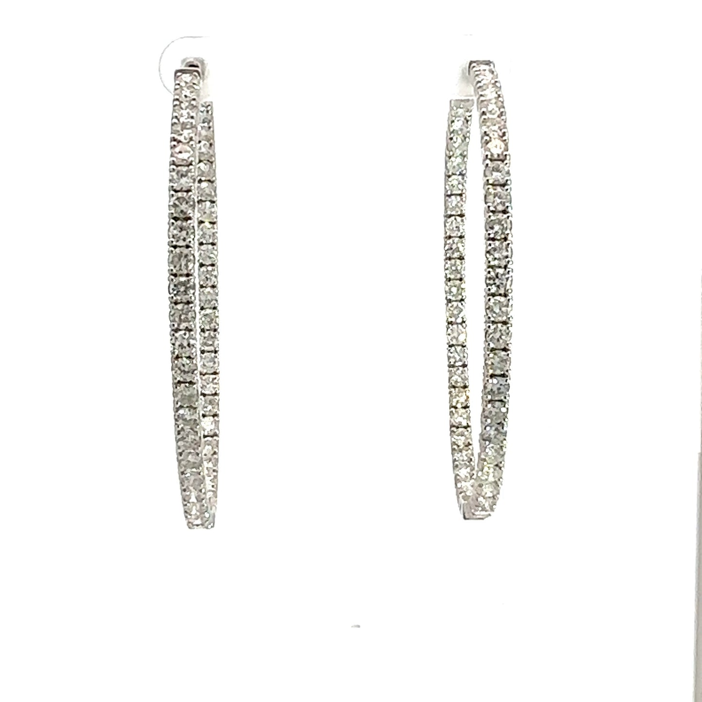 Front of large white gold diamond hoops with diamonds on front and inside
