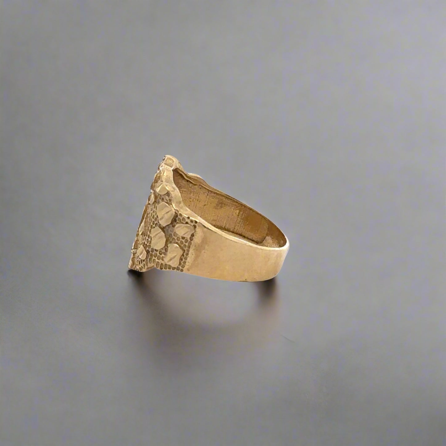 Side of yellow gold nugget ring. Shows scratches