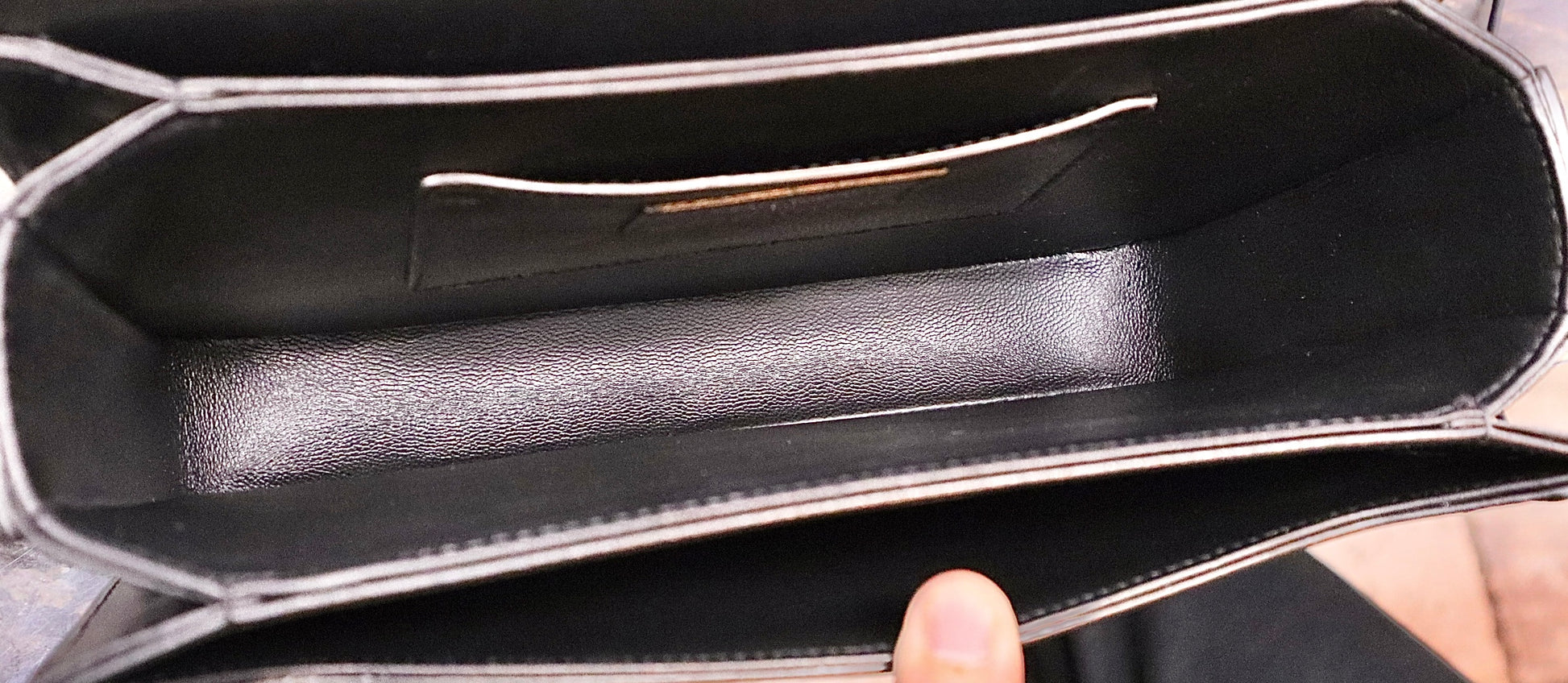 Inside of bag with black leather
