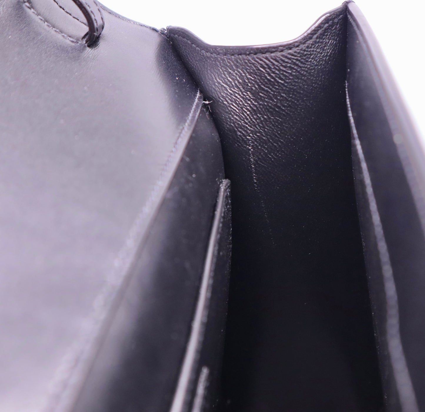 Inside, side of black bag with scuff mark on side 