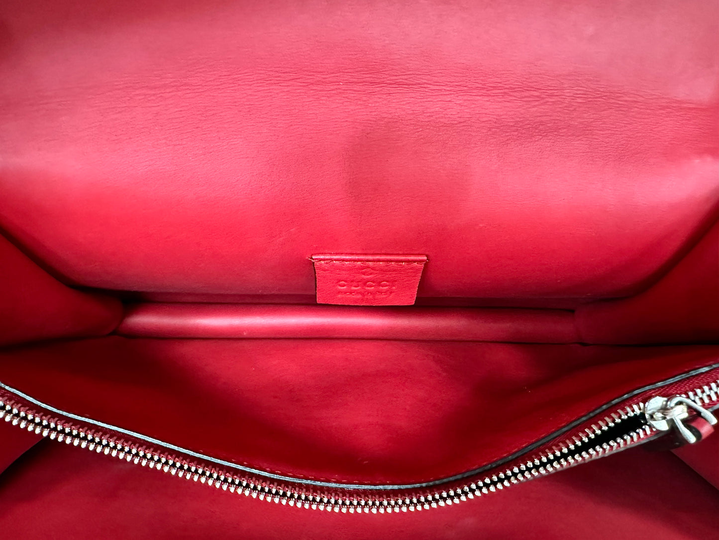 Close up of 1 of the compartments inside red leather