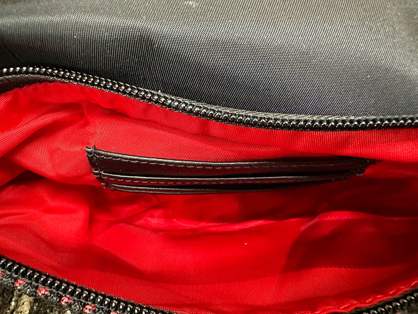 Red interior of pocket with black card slots