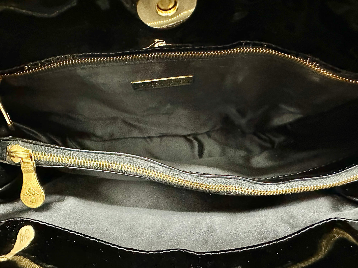 Black interior of bag with 1 zip-pocket and 2 other compartments