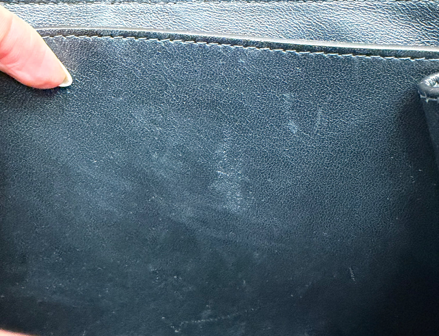 Close-up of the black leather interior with scuff marks on the interior.