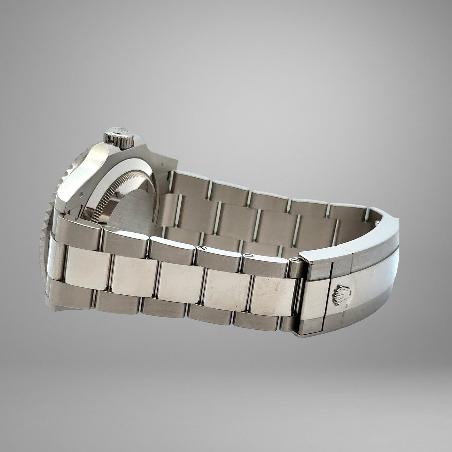 Silver watch with a detailed band on a gray background