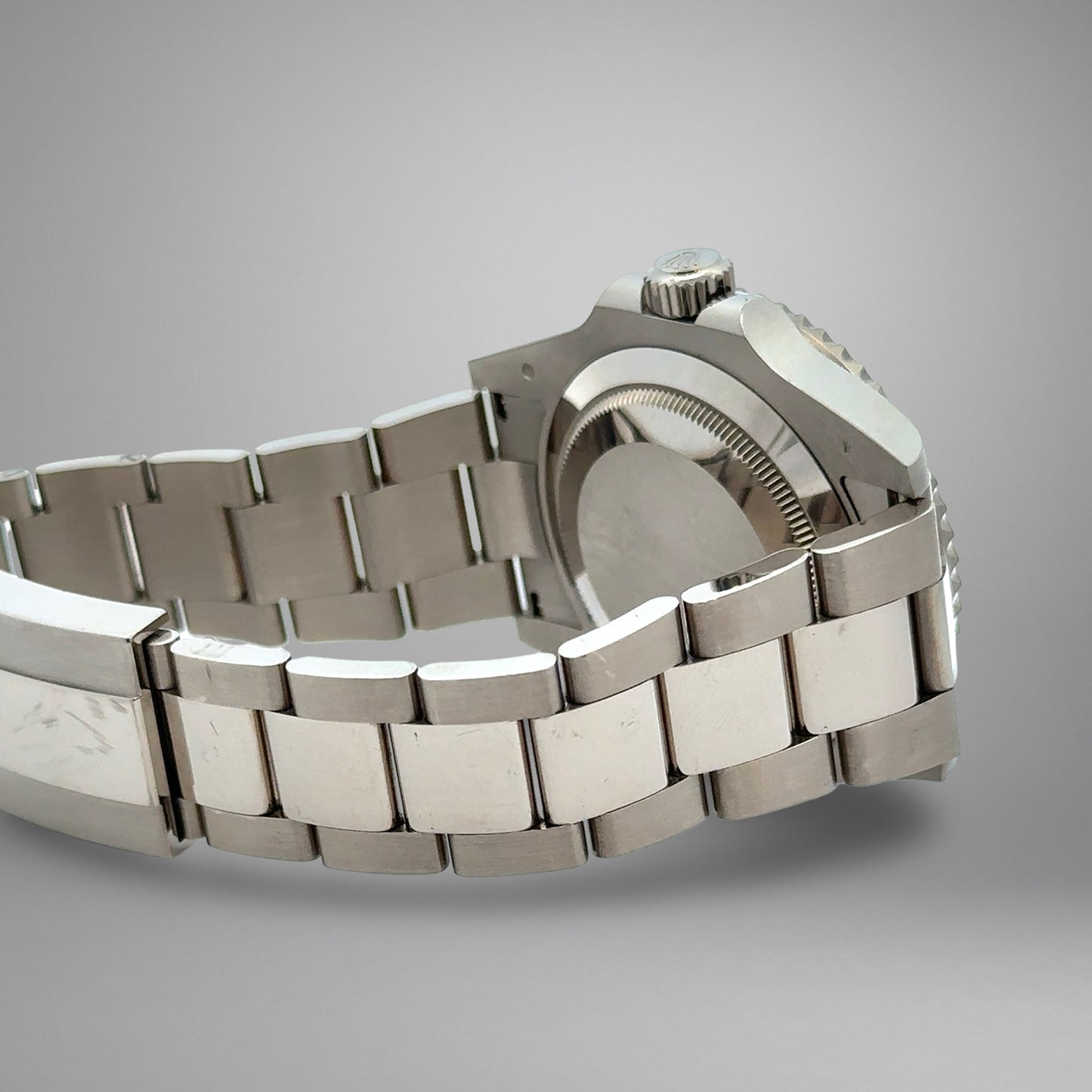 Silver watch with a metal bracelet on a gray background