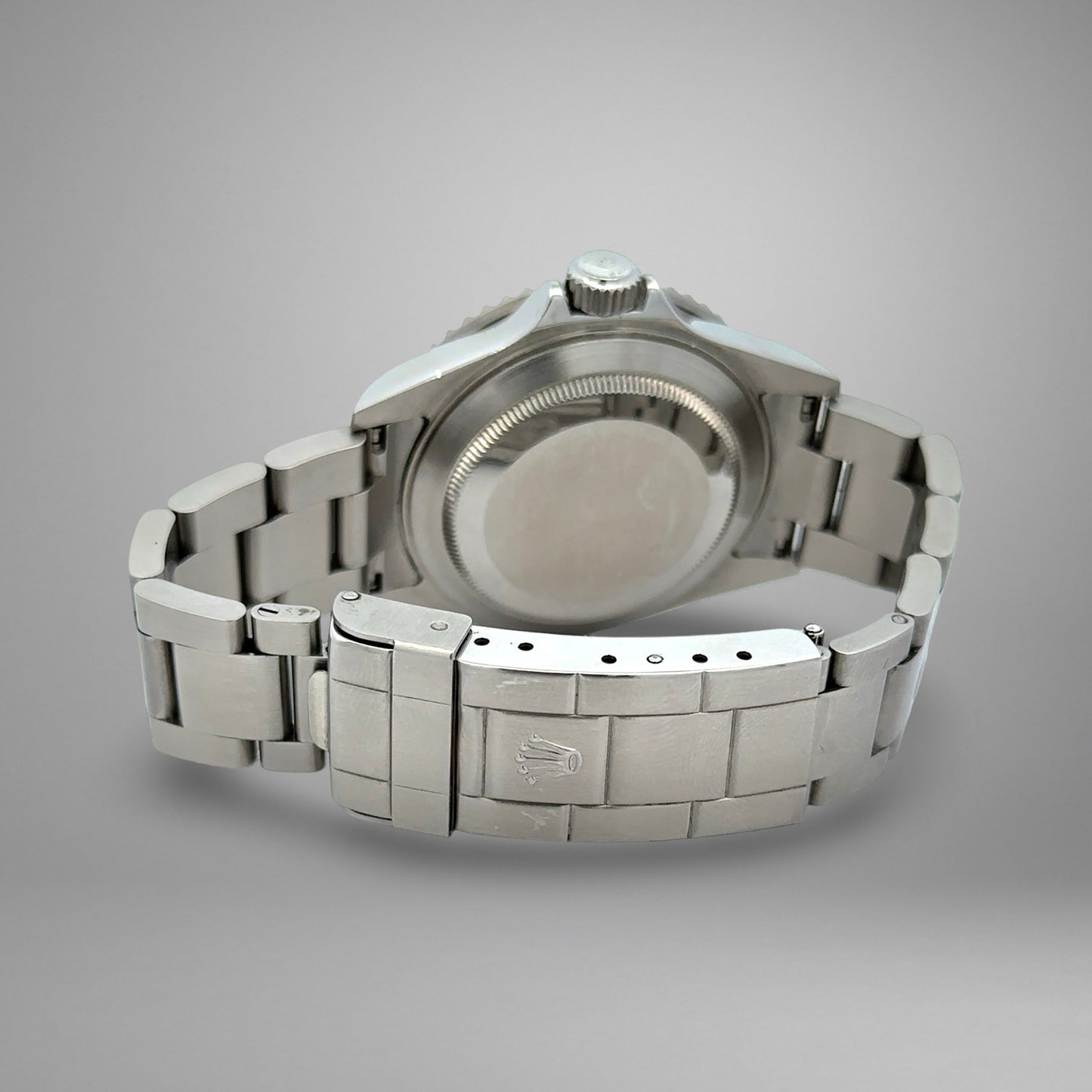 Silver watch with metal band on a gray background