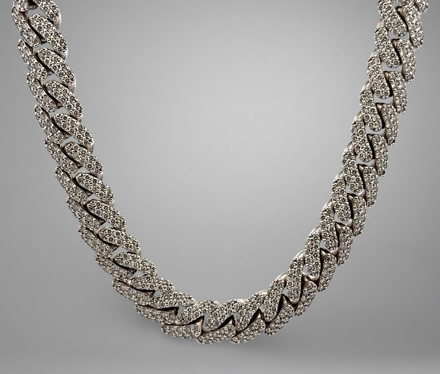 Silver chain necklace on a gray background
